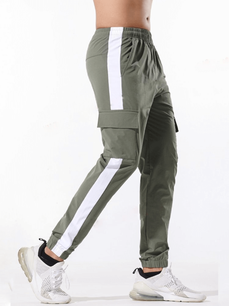 Side view of men’s casual sports pants SF1520 with large pockets, highlighting 100% polyester fabric and elastic waistband for a comfy fit.